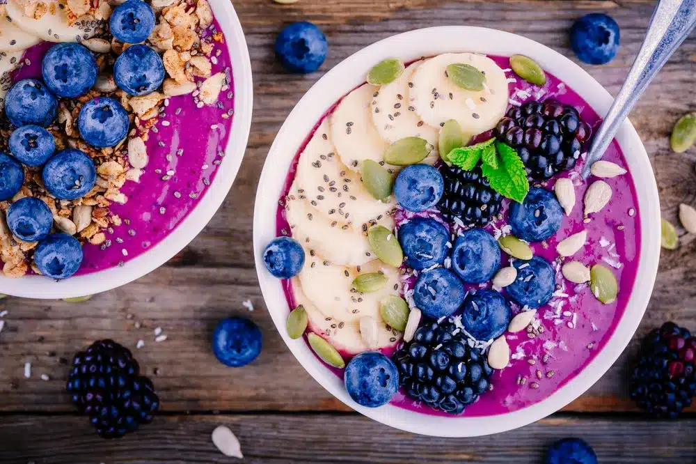 A colourful superfood bowl with chia seeds, fresh berries, and almonds, perfect for nourishing your body after fasting