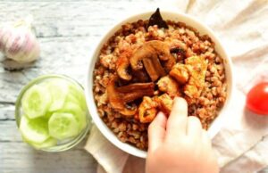 Baked Portobello mushrooms served with fresh herbs and cucumber slices – a Vitamin D-rich plant-based recipe.