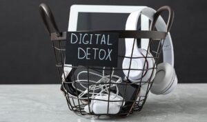 Close-up of turned off tablet, headphone and smartphone in a dustbin, symbolising a digital detox.