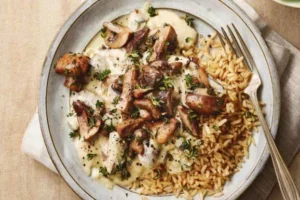 Vegan mushroom stroganoff served with brown rice, topped with fresh parsley